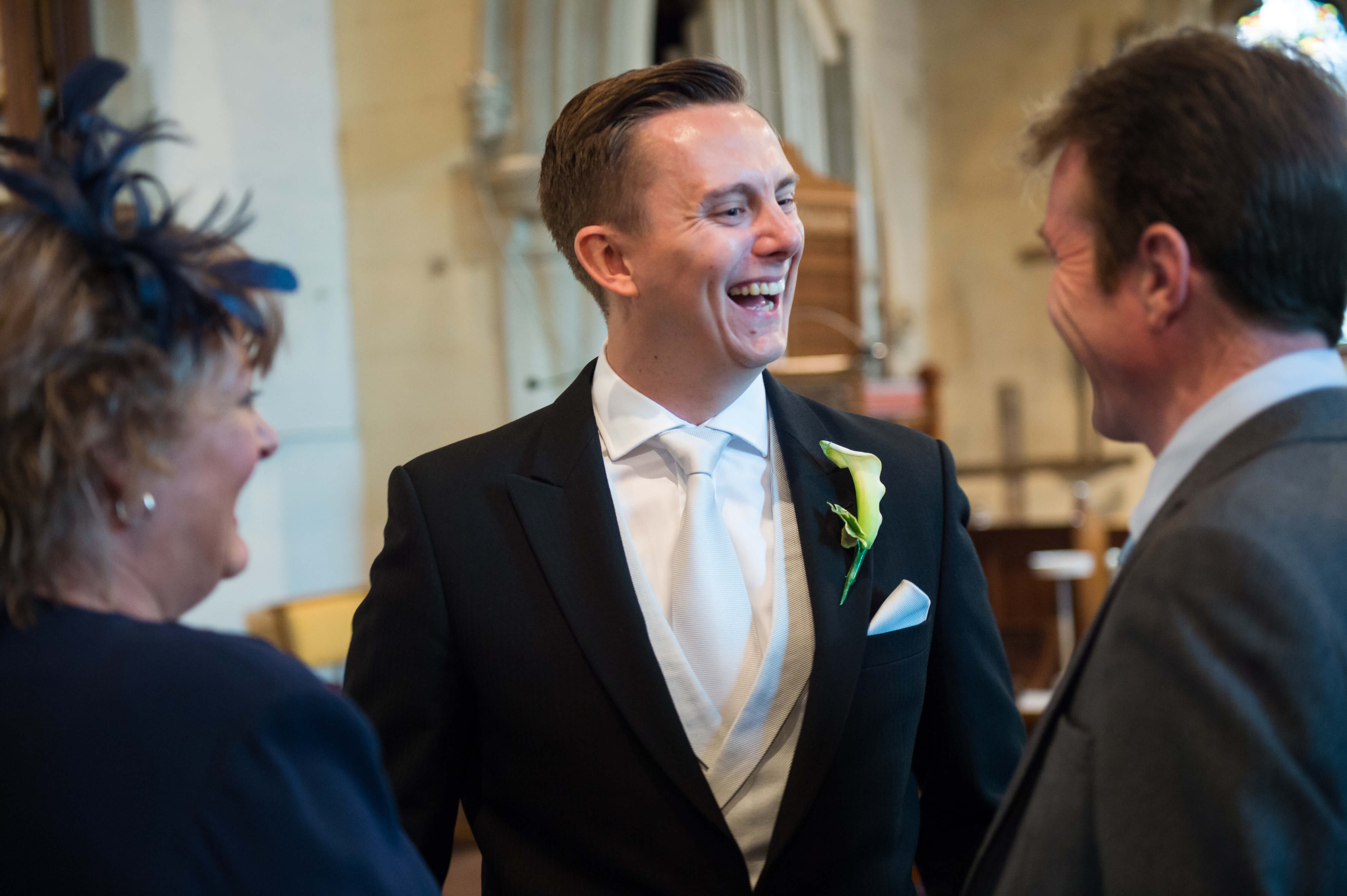 groom laughing with his friends before the wedding by especially amy wedding photography